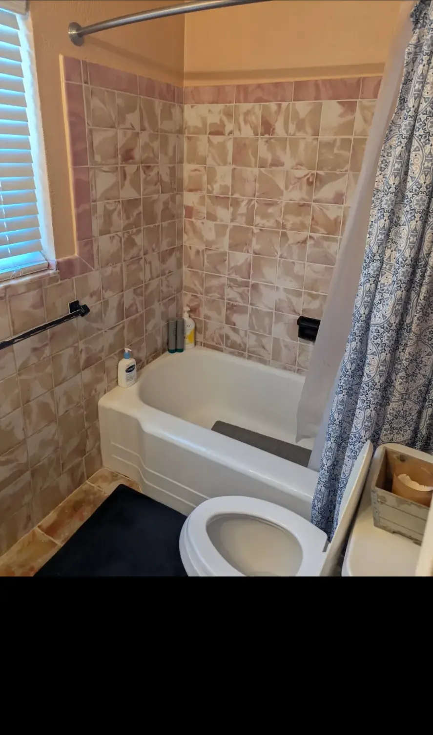 Before: Hall bathroom with tiled shower and bench