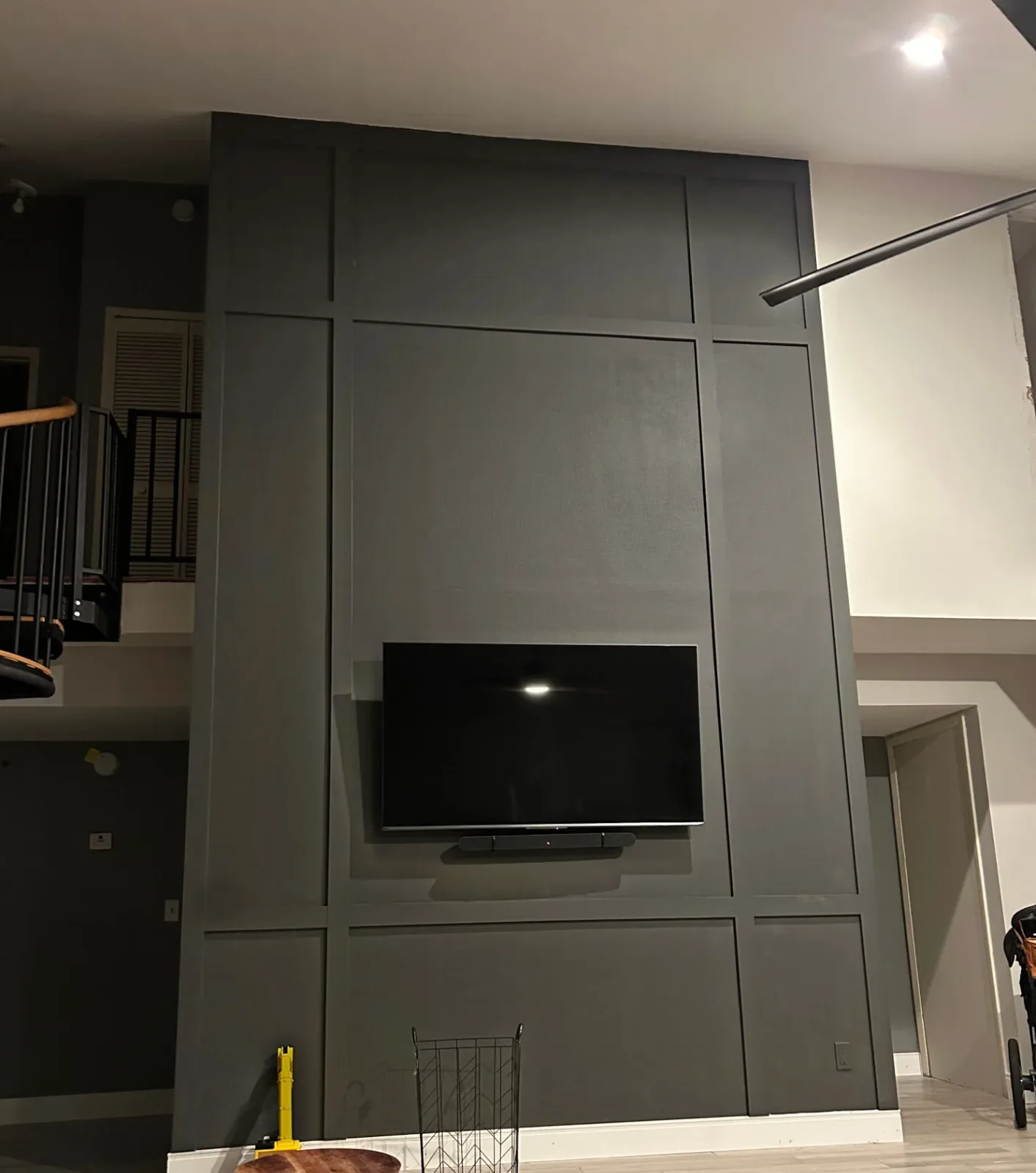 After: Two-story living room wall with charcoal grid-panel trim