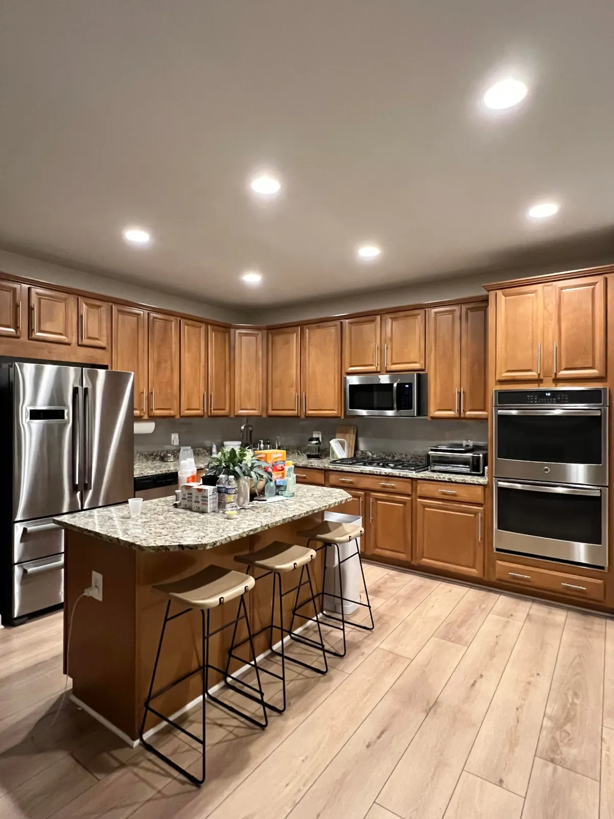 Before: Kitchen remodel with brass accents and marble-look counters
